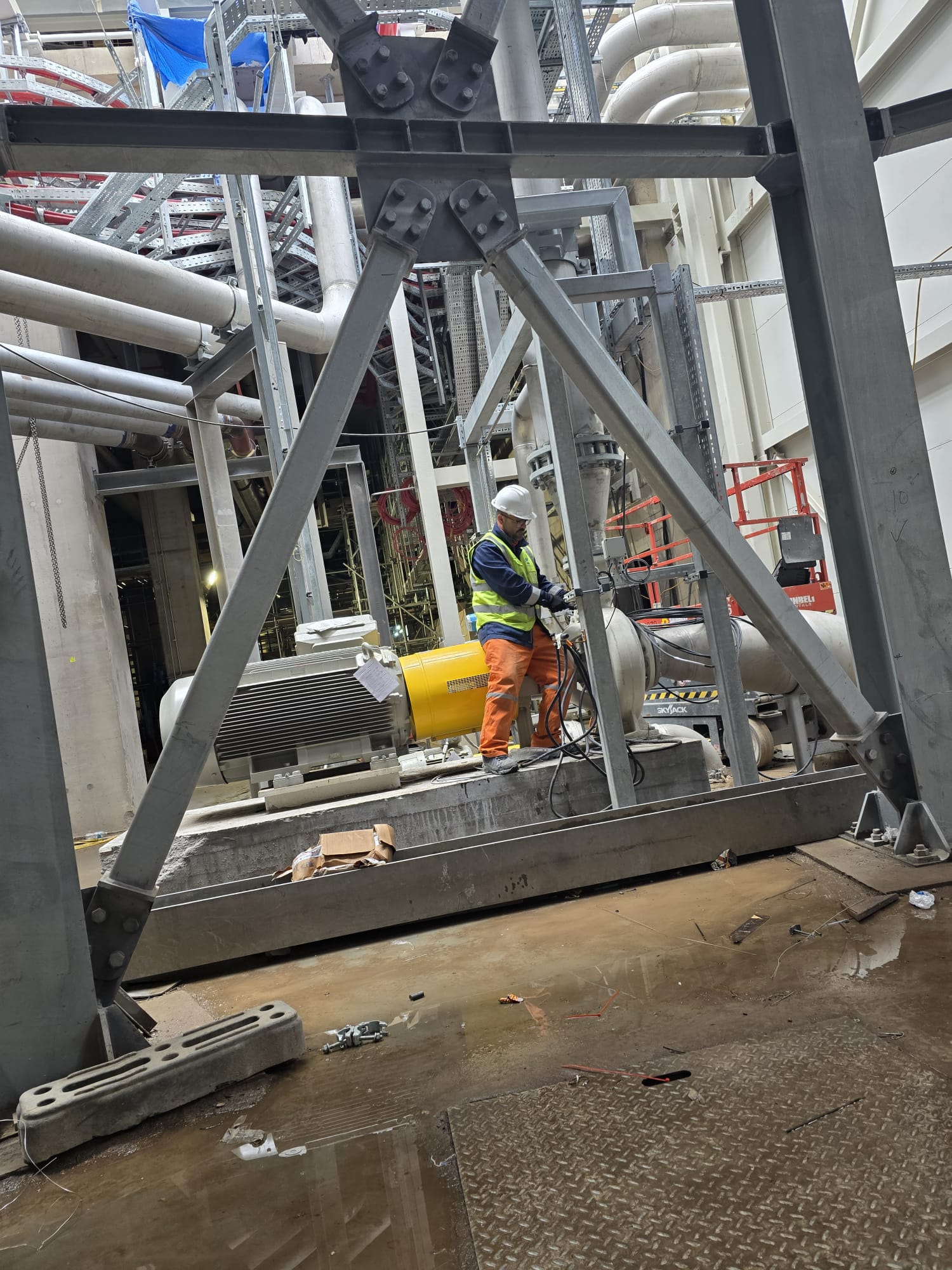 Heavy pump installation work in an industrial facility