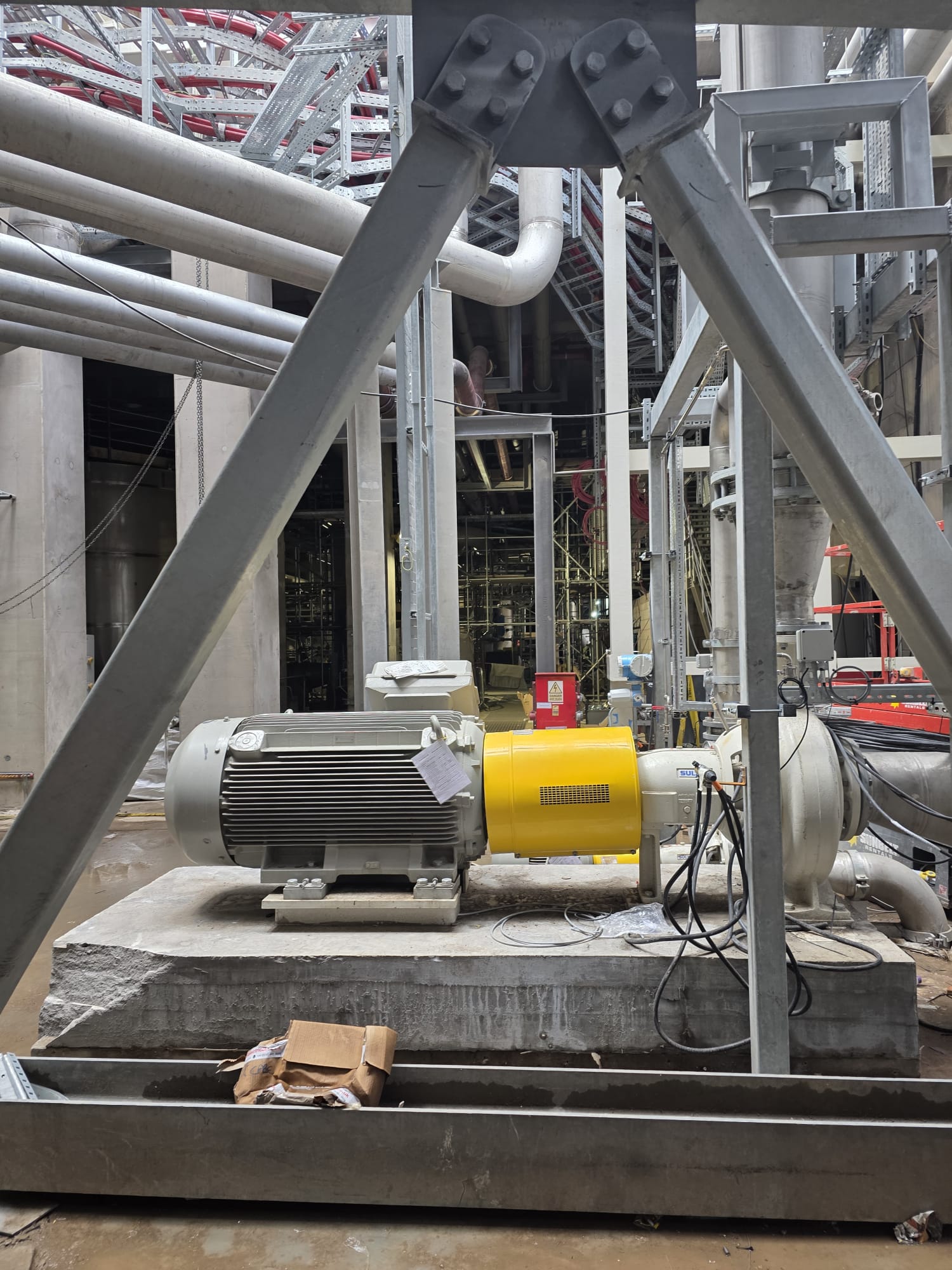 Industrial motor and pump unit installed on a concrete plinth